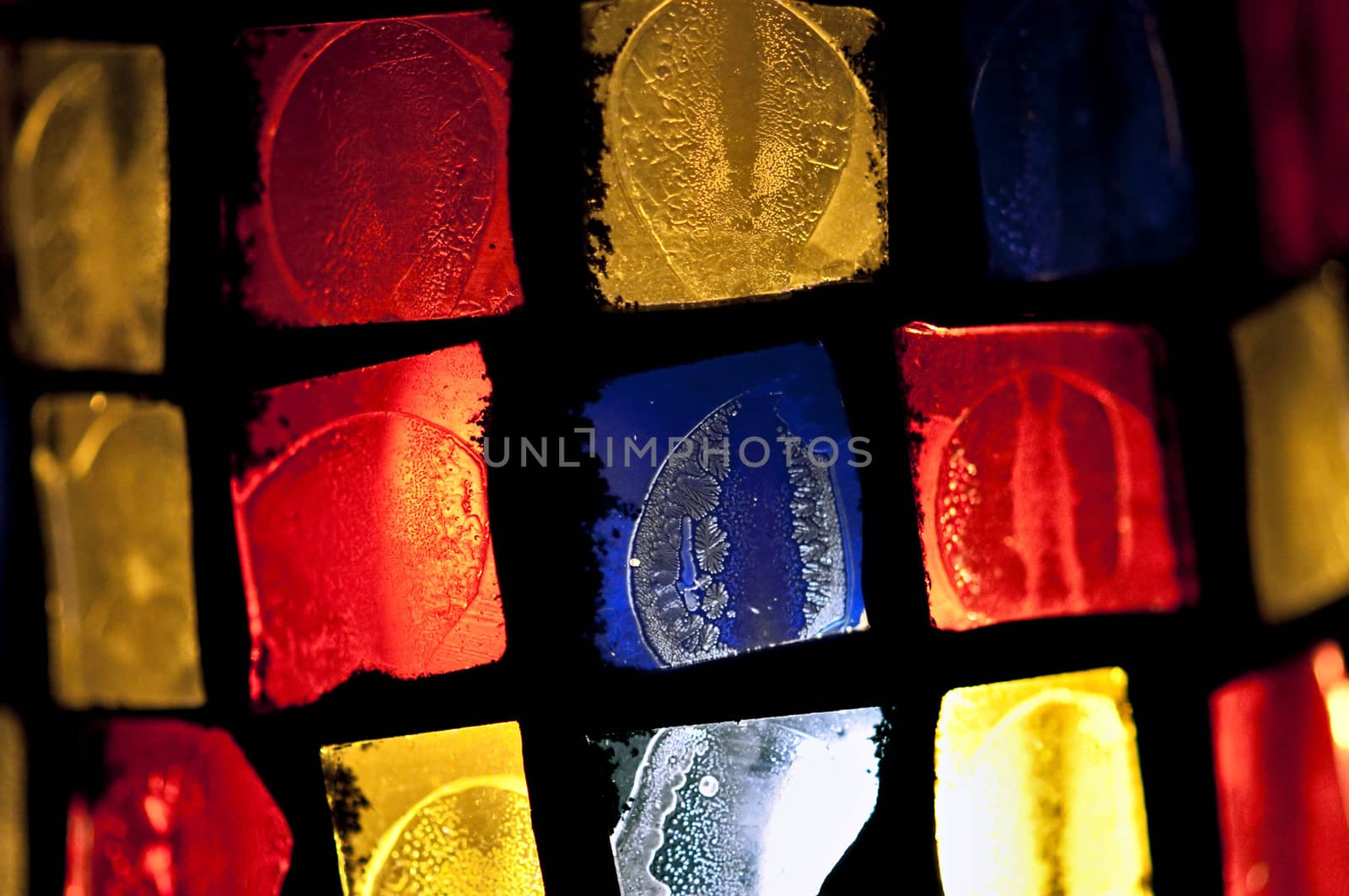 Colorful stained glass abstract squares pattern. Selective focus.