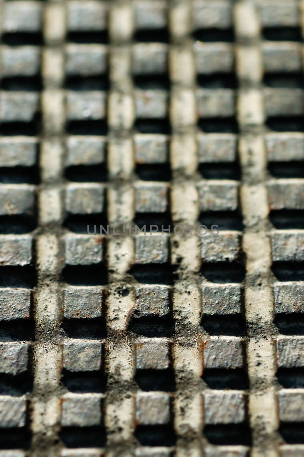 Rusty industrial metal surface with squares pattern. Selective focus.