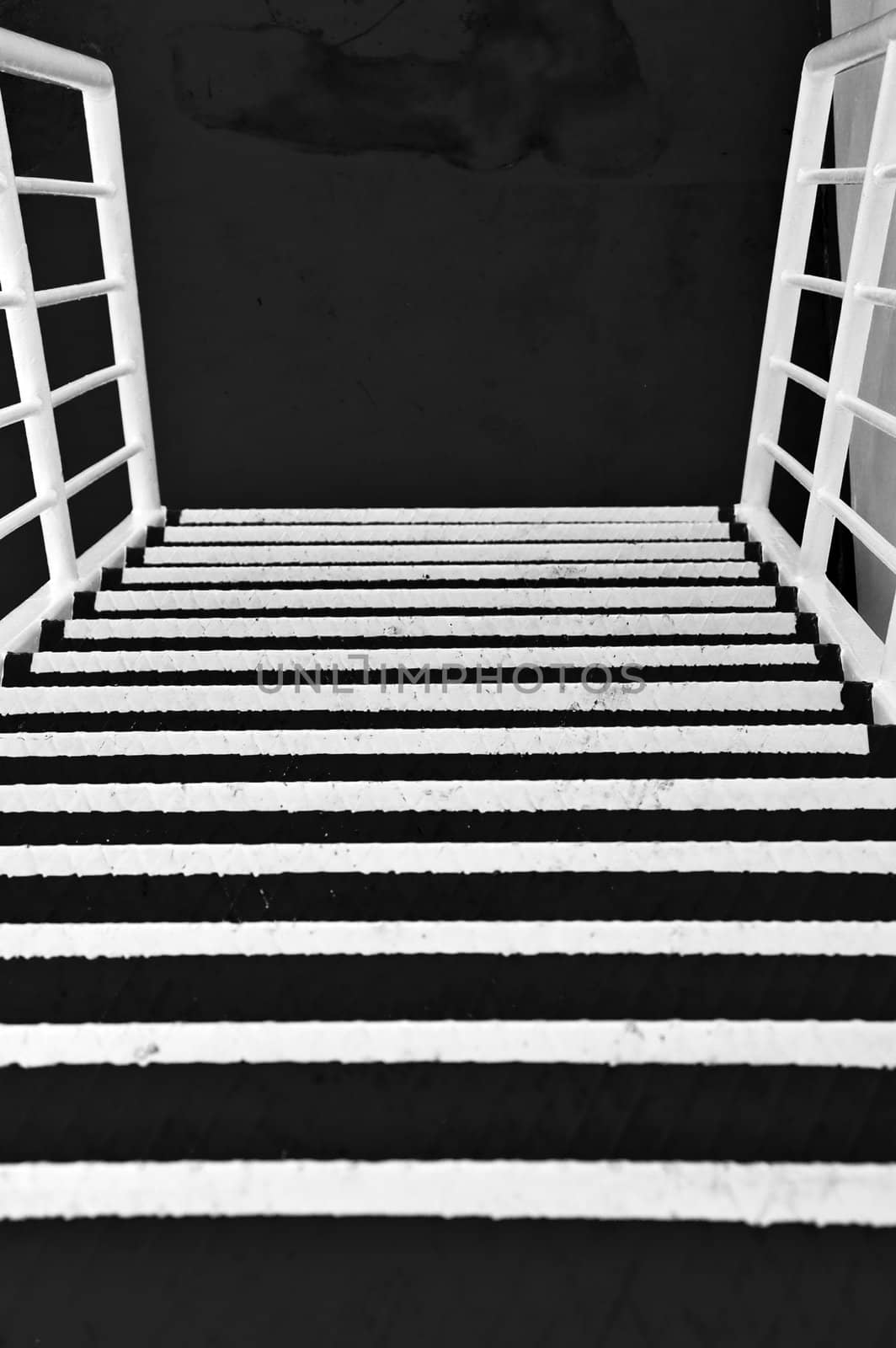 Metal stairs on a ferry boat. Black and white.