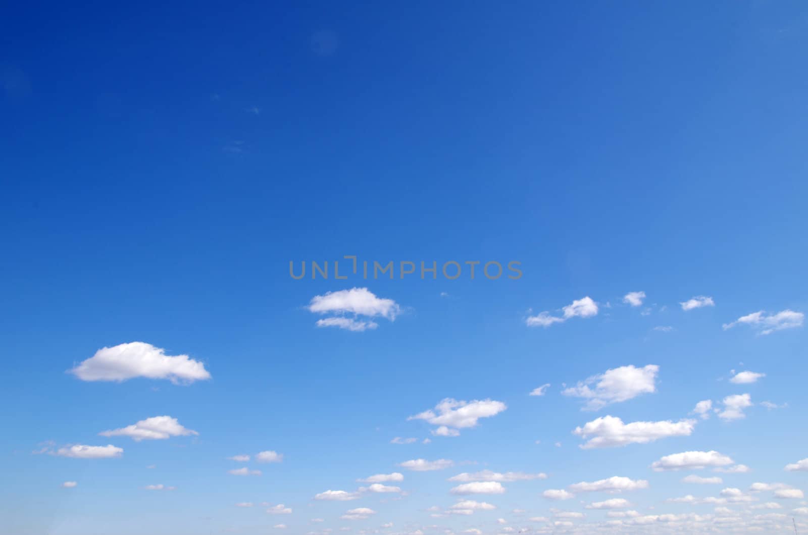 blue sky background with tiny clouds