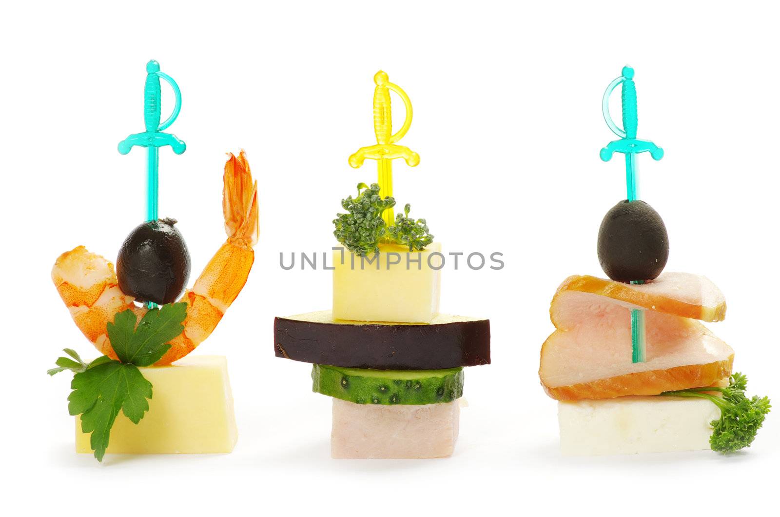 Close-up of canape with olives, cheese and over white