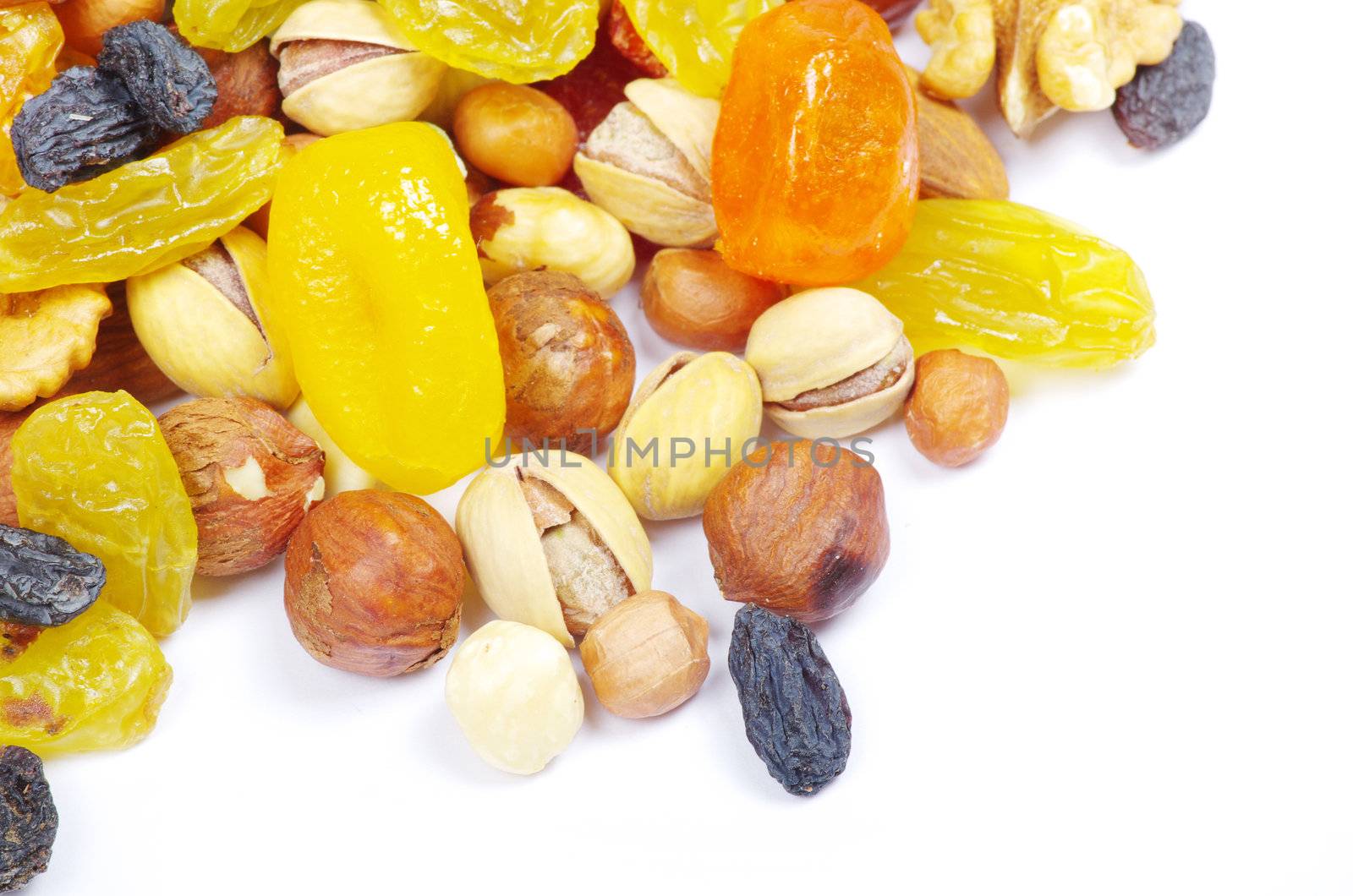 Groups of various nuts of dried fruits on white background