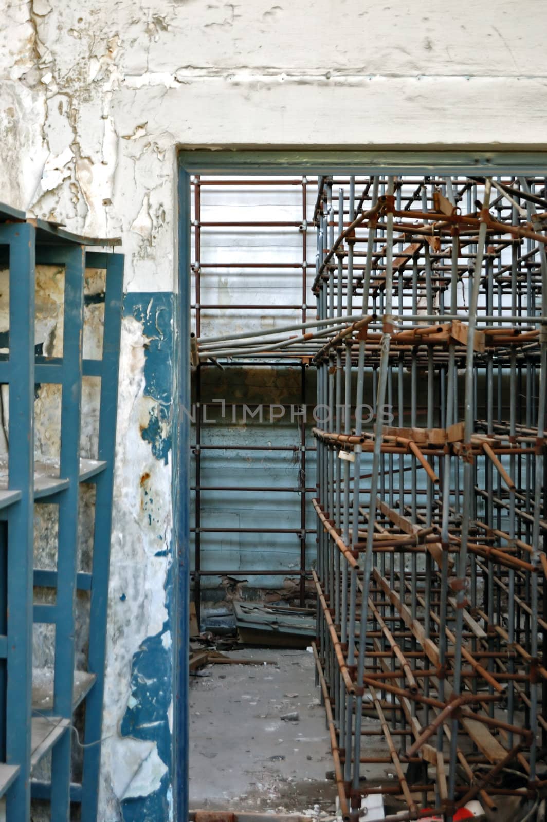 Storage room with empty industrial shelves in abandoned factory.