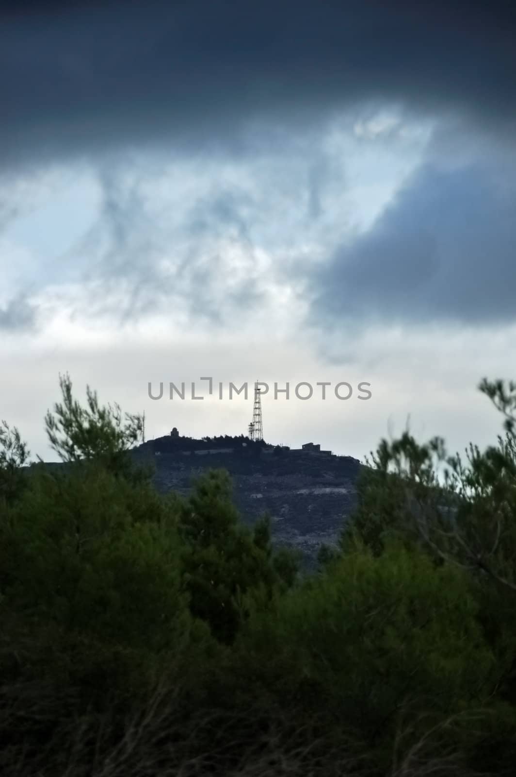 Overcast winter sky over a small hill.
