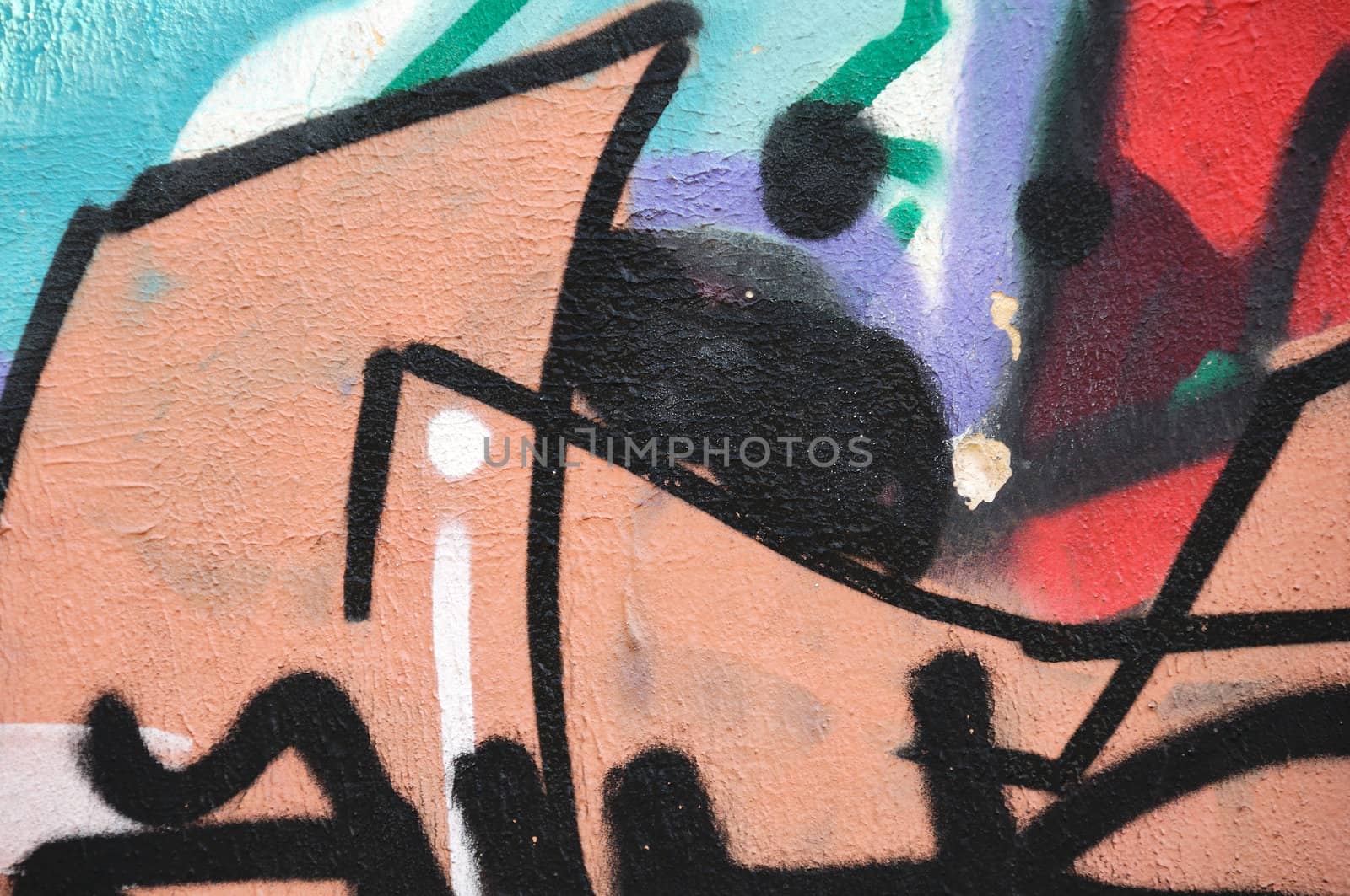 Abstract graffiti on weathered wall. Urban street art.