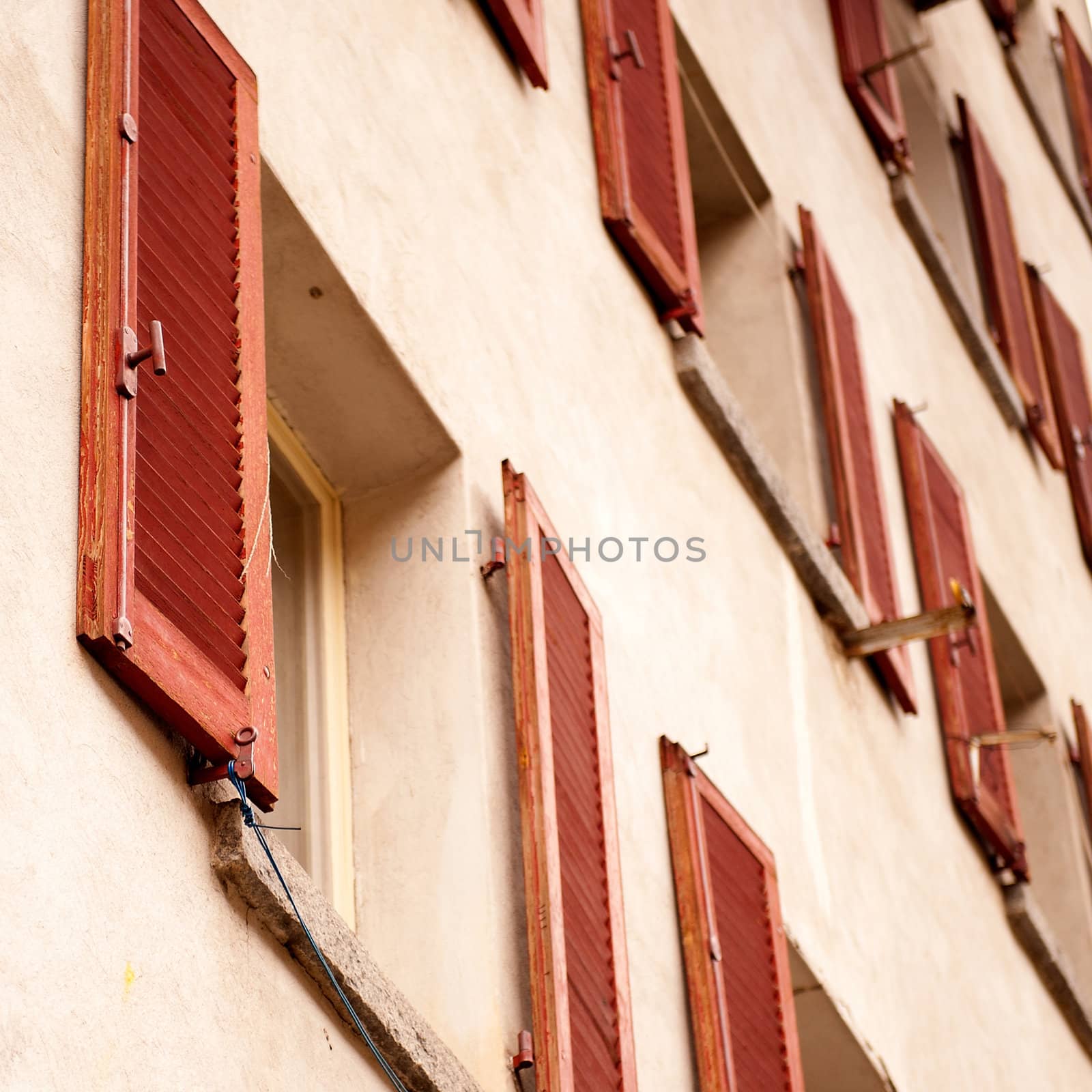 a wall with a lot of red windows