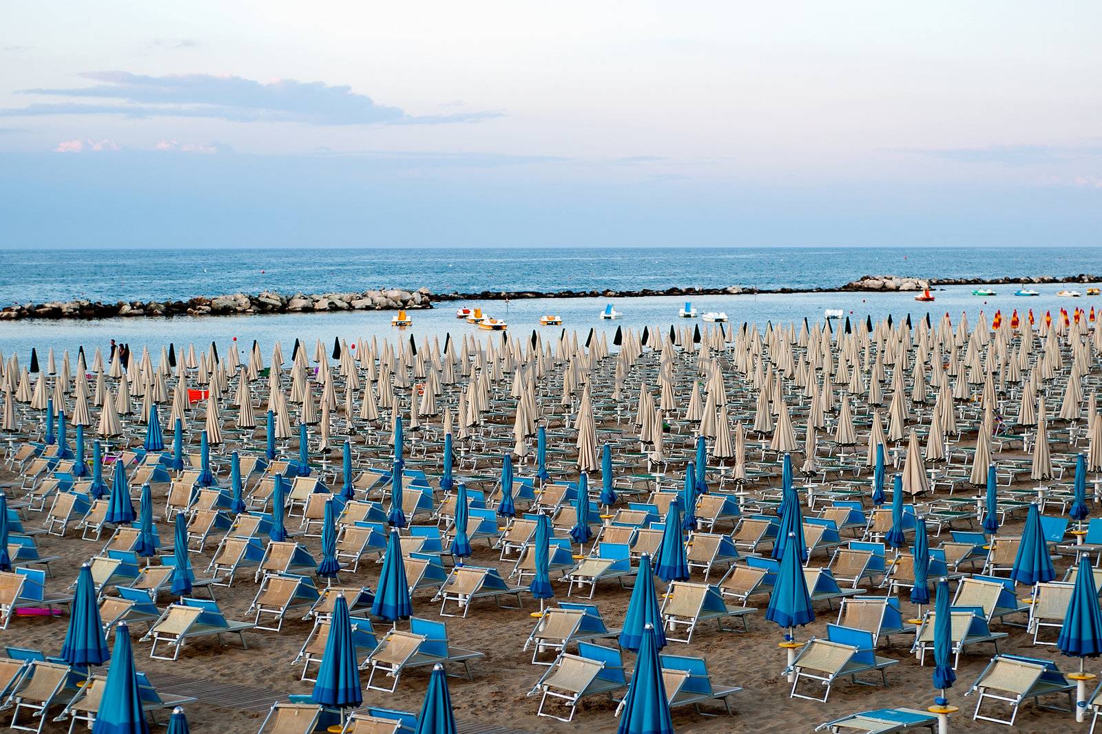 a panoramic view of the beach with chairs and umbrellas