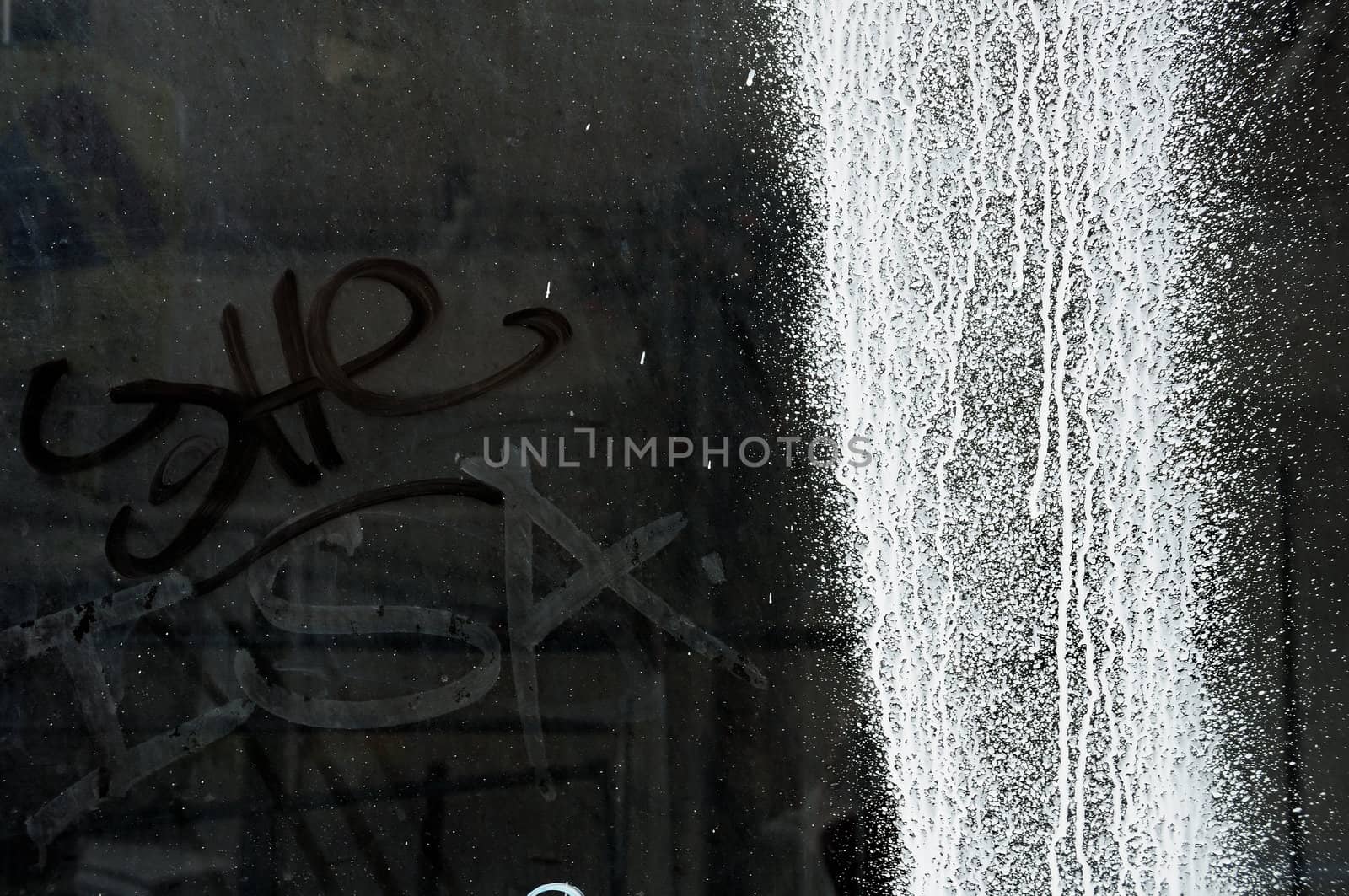 White paint splashed over a dusty glass surface. Grunge texture.