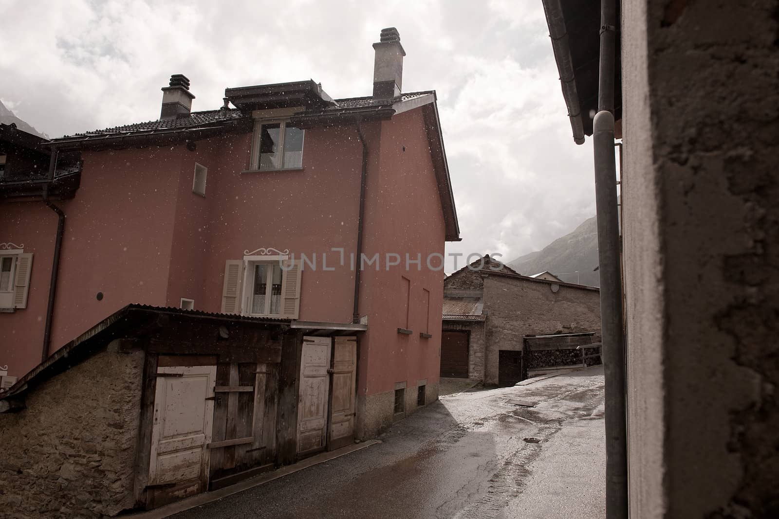 a street in a village on a rainy day