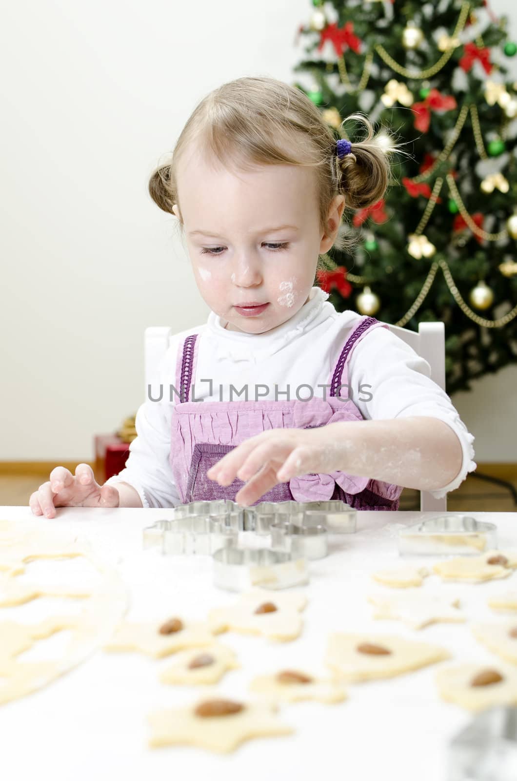 little cute girl making Christmas cookies