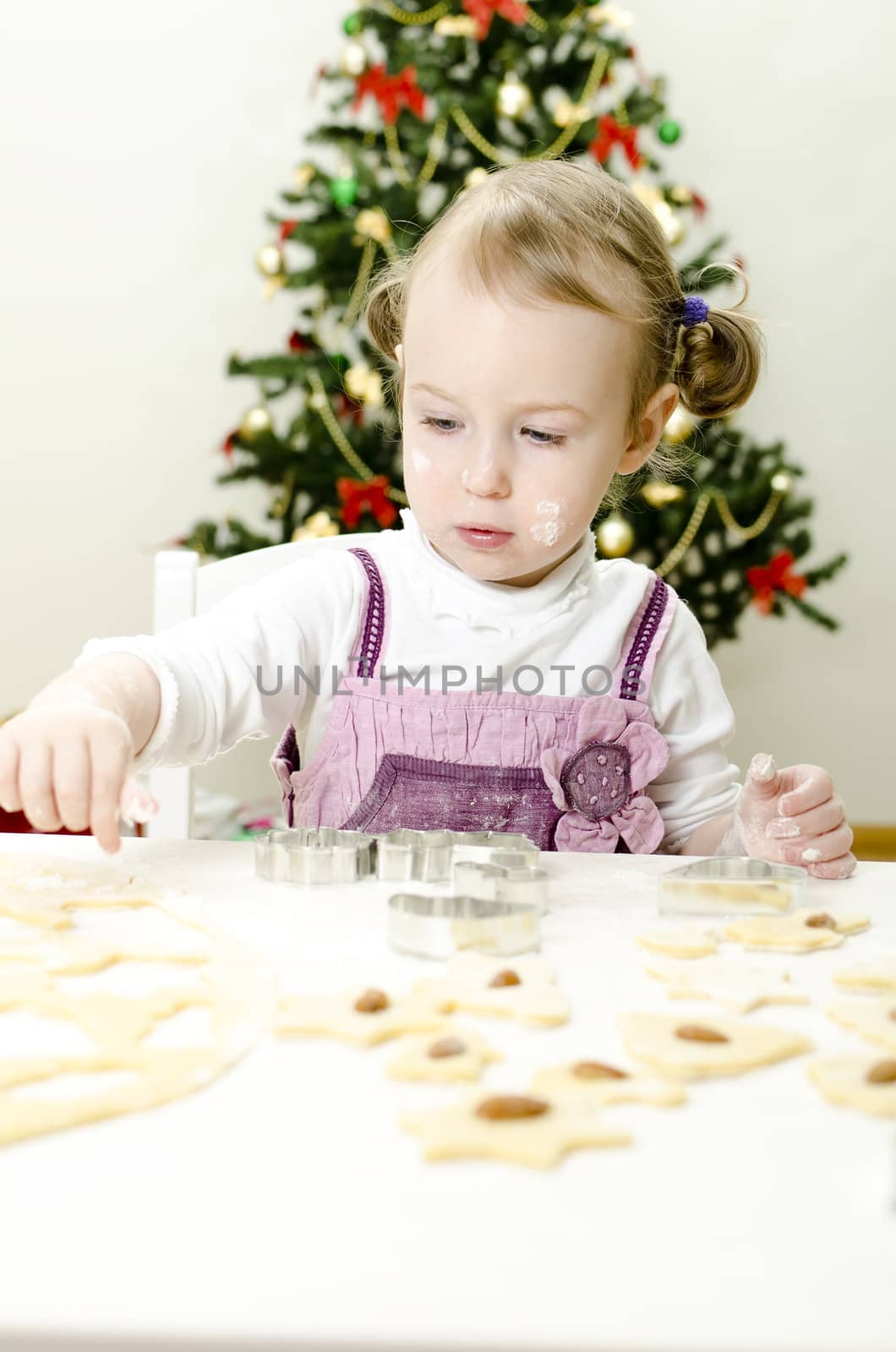 little cute girl making Christmas cookies