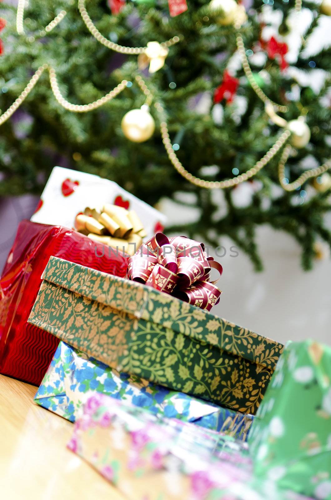 few gifts at Christmas tree