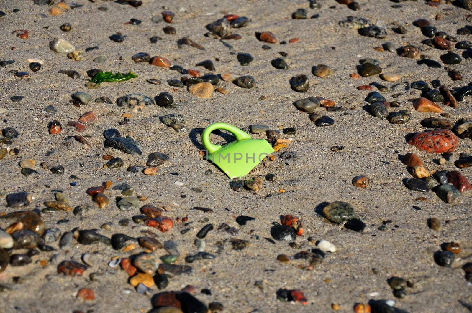 shard in the sand on the seashore, a broken coffee cup