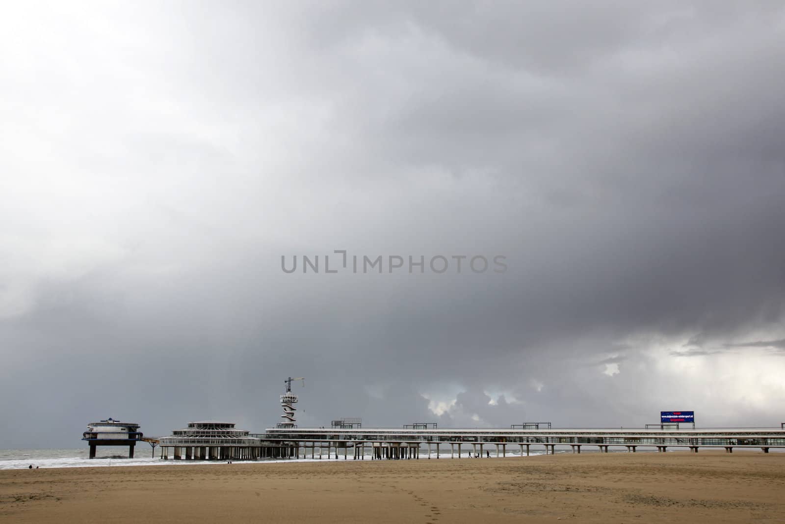 pier of Scheveningen with grey sky by ahavelaar