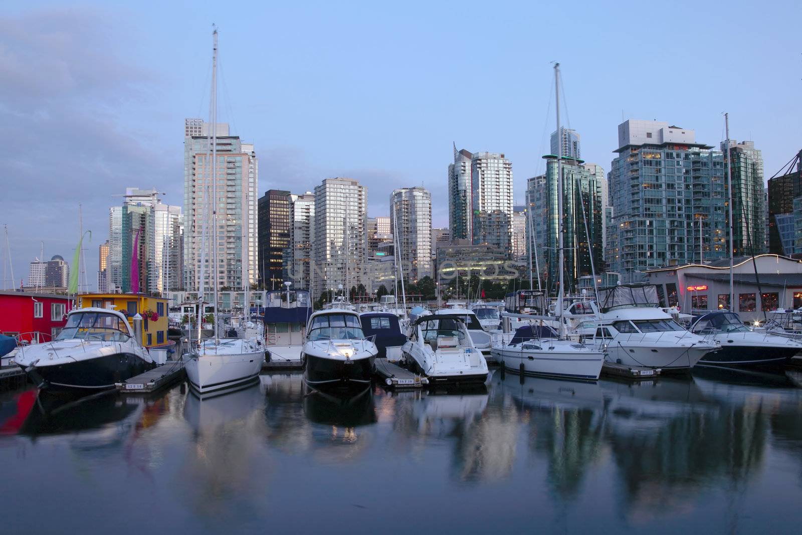 A marina and skyline view of Vancouver BC Canada at dusk.