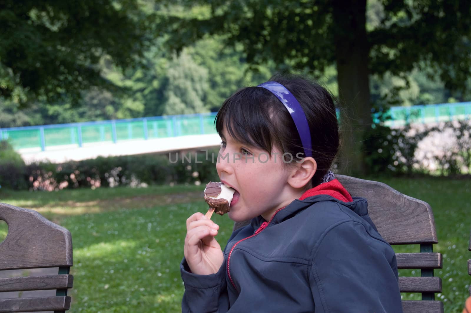 Freckled girl eating ice cream.