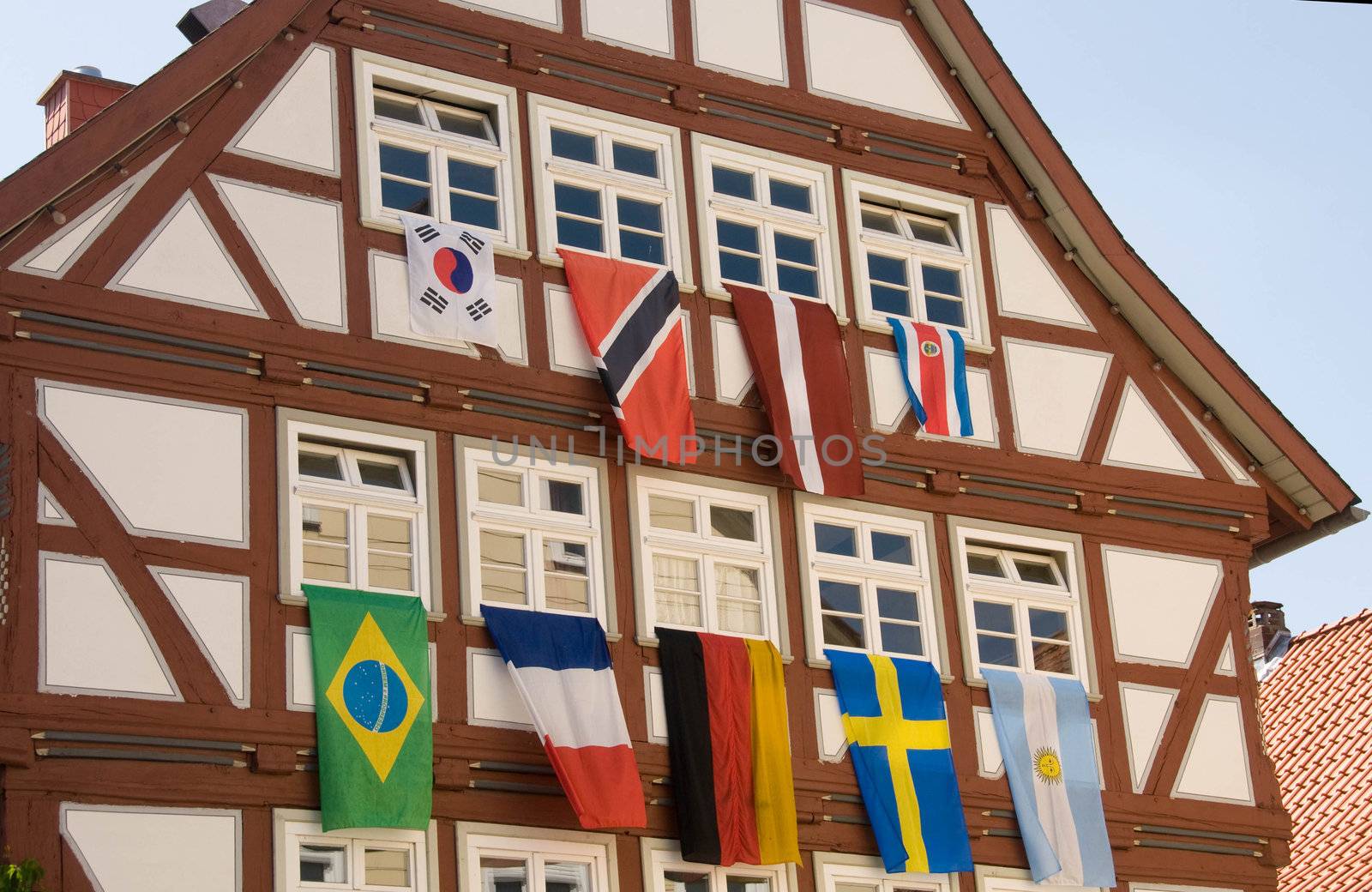 Flags of different countries on the background of half-timbered facade.