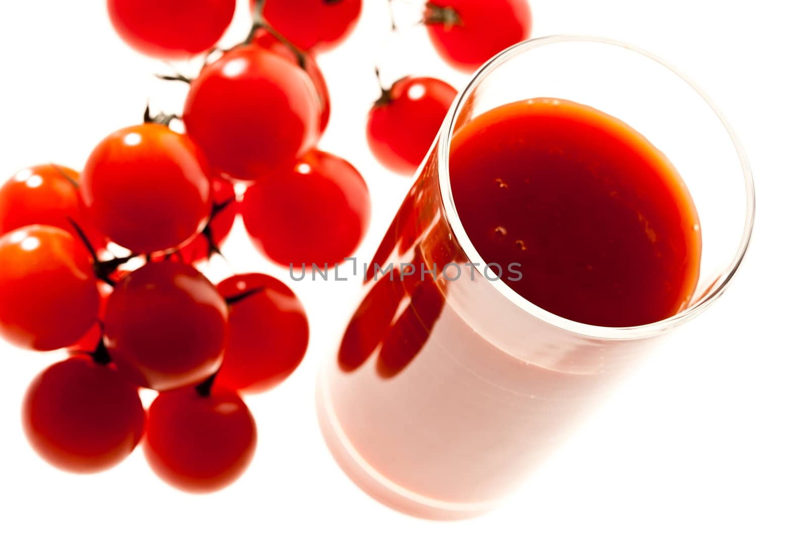 food series: branch of red tomato and juice over white