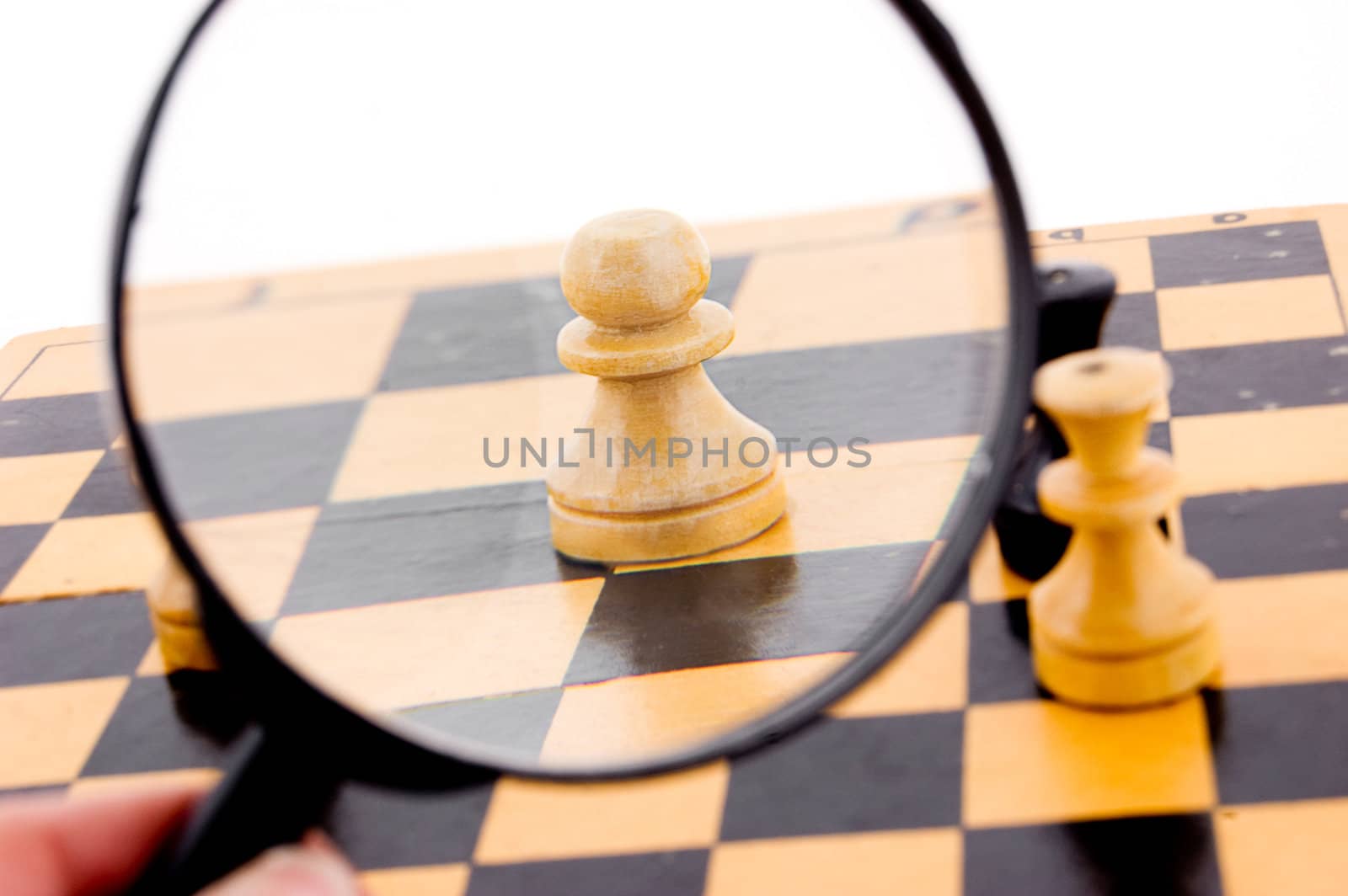 Pawn chess under magnifying glass