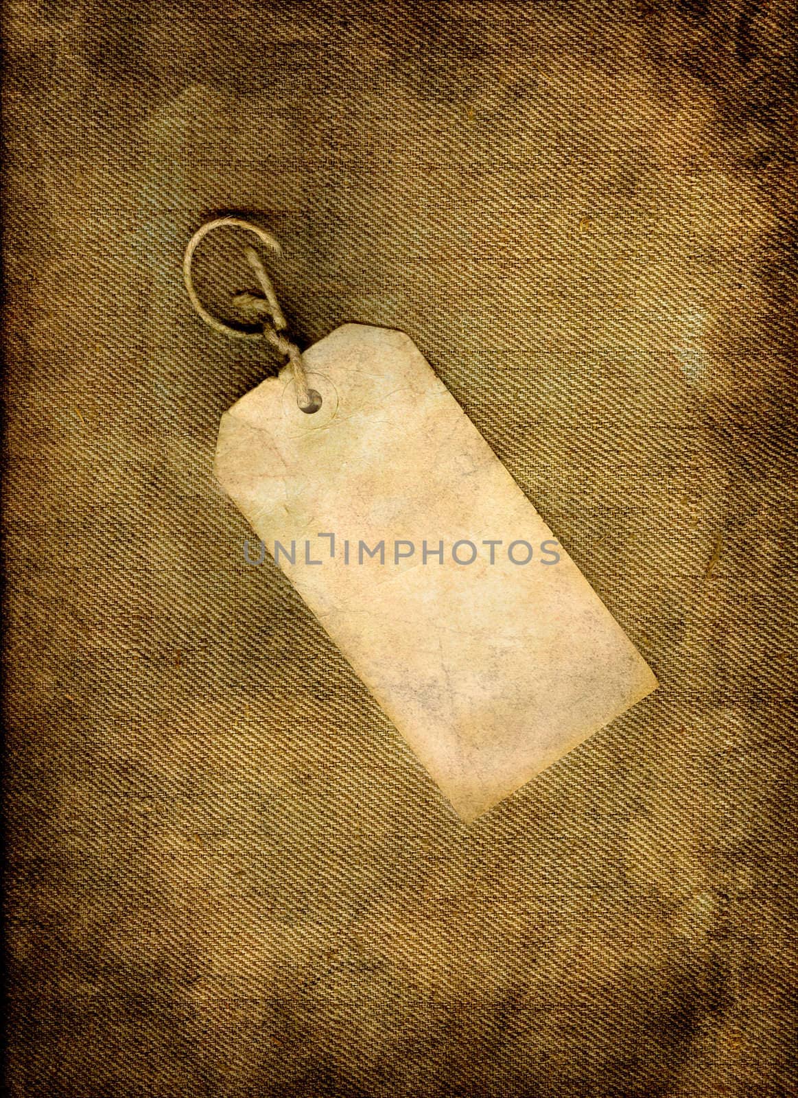 Blank vintage, paper tag on linen in grunge.