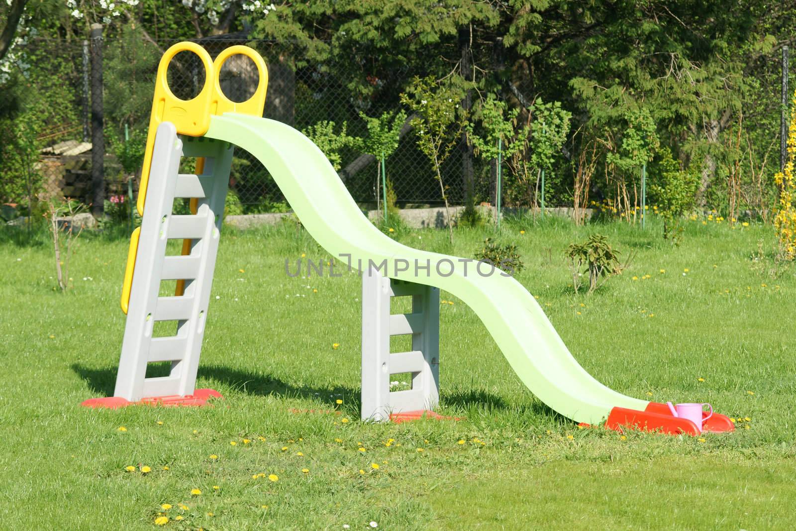 Colorful plastic slide in the garden.