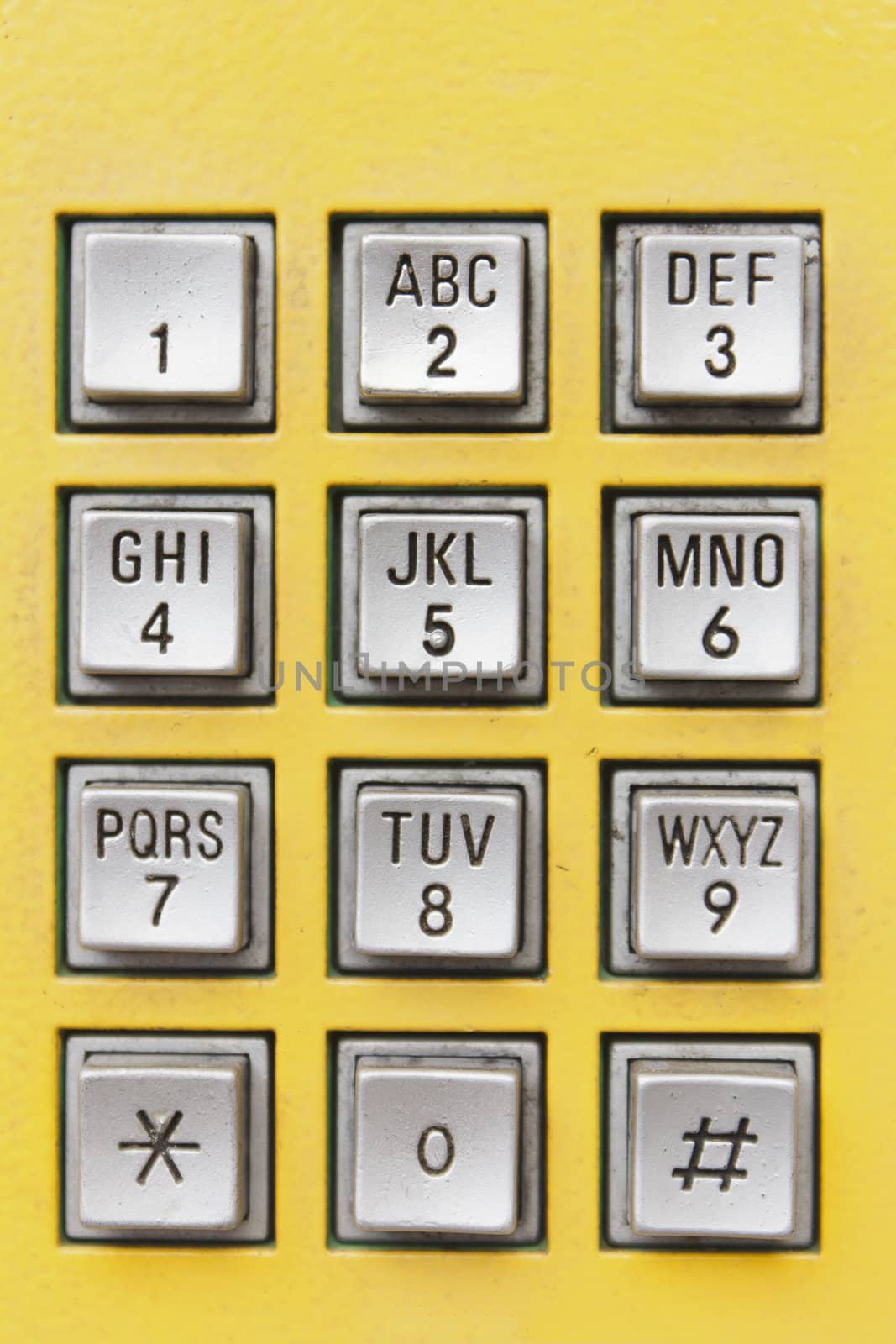Buttons on yellow public telephone in Thailand