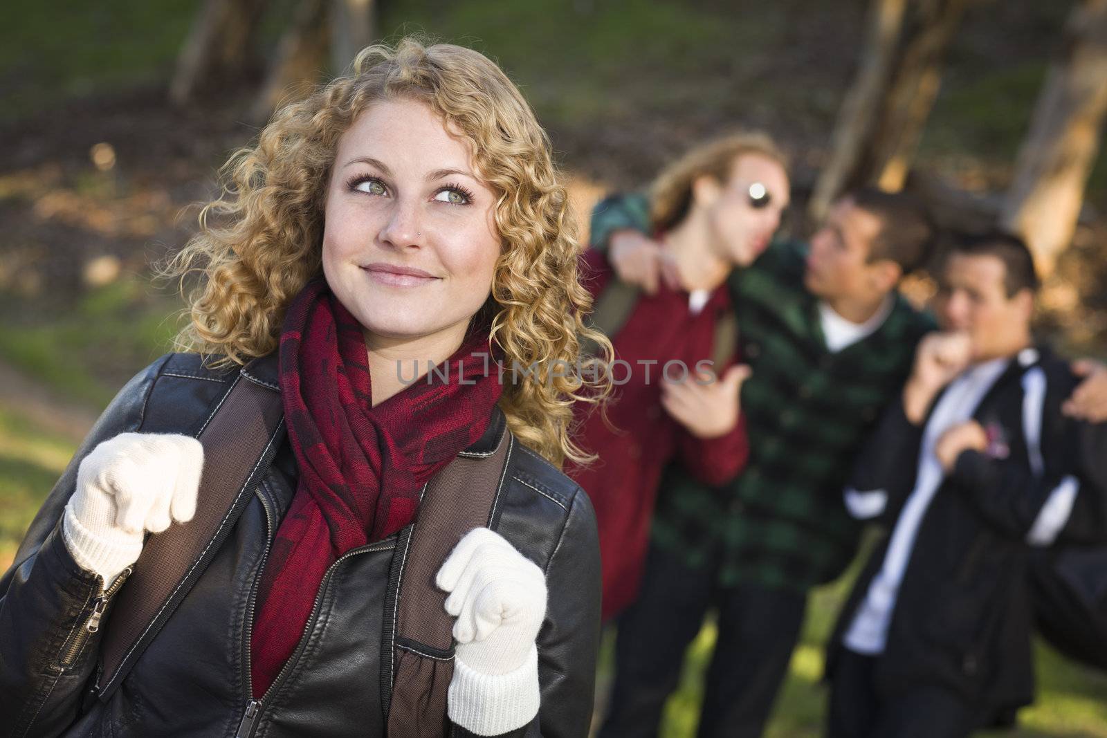 Pretty Young Teen Girl with Three Boys Behind Admiring Her.
