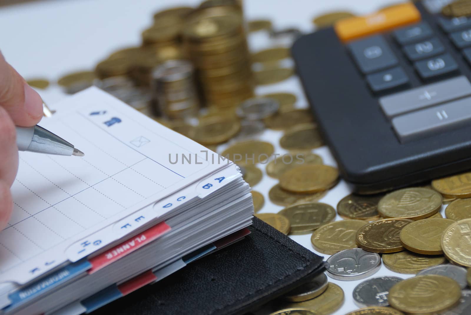 Business concept - diary, coins and calculator 