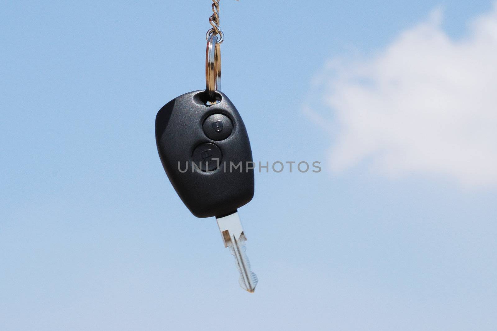 New car key against a blue sky  