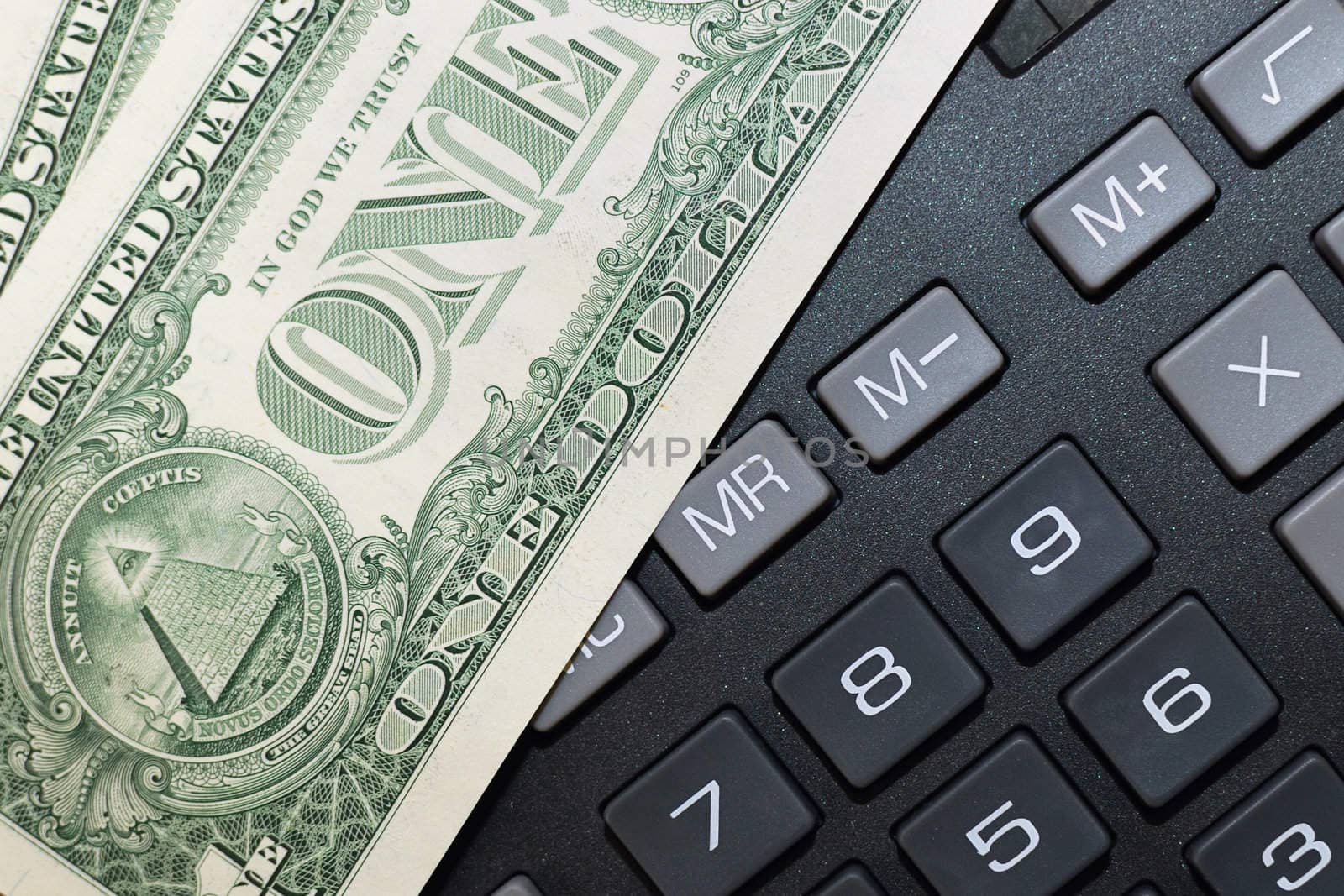 Money on keypad of a calculator close up