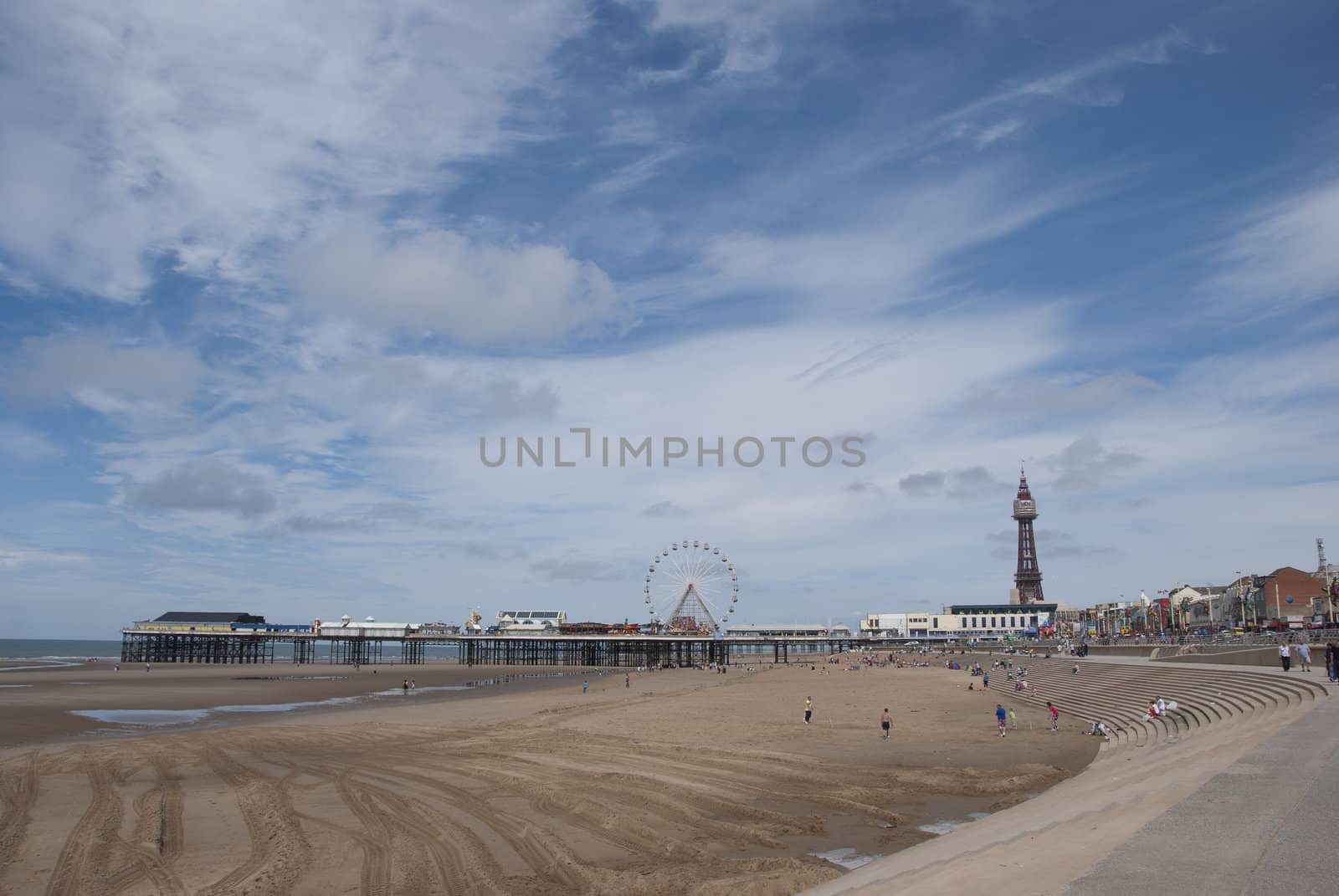Central Pier and Blackpool Tower from the beach under a blue sky