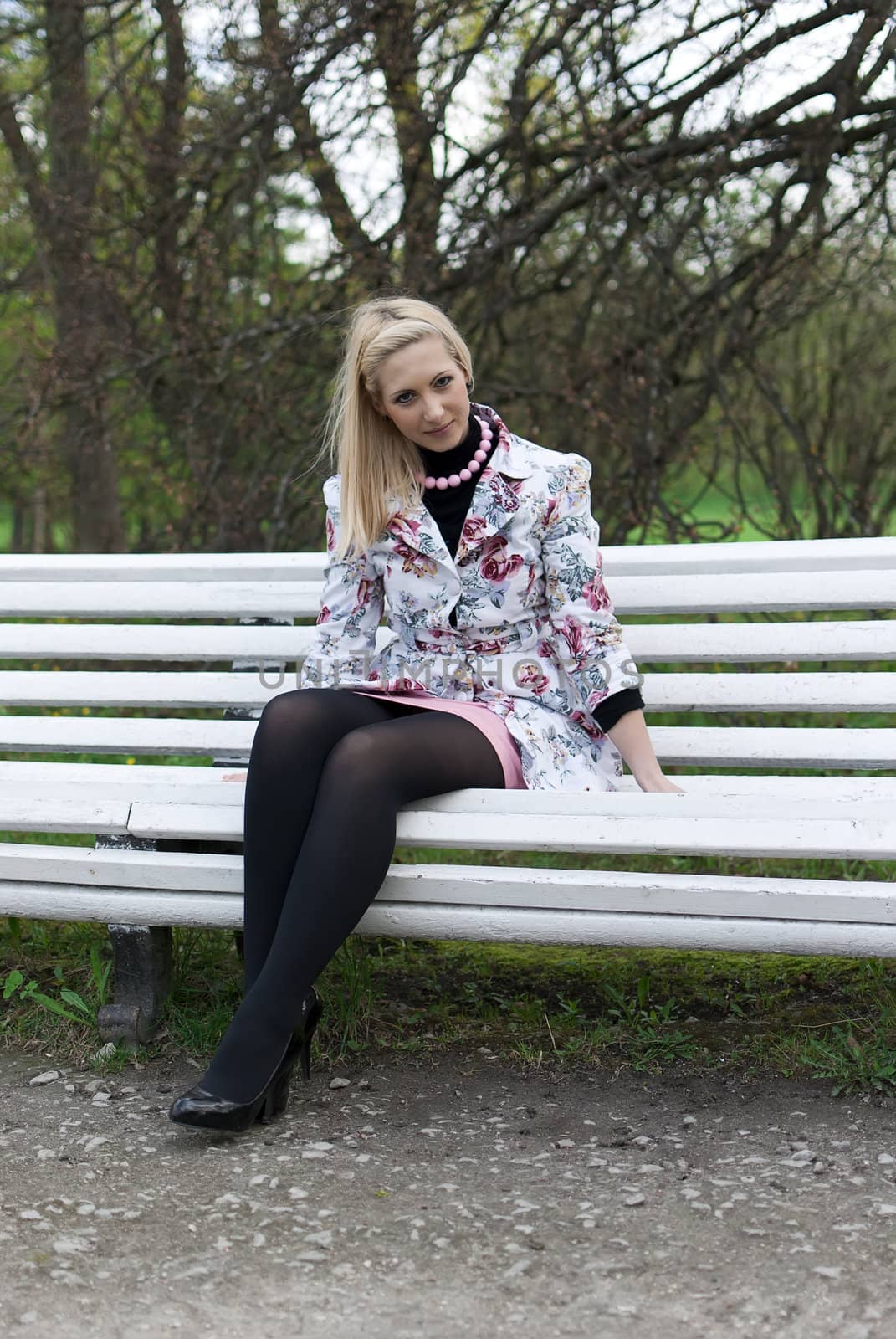 blonde girl sitting on a park bench  by dmitrimaruta