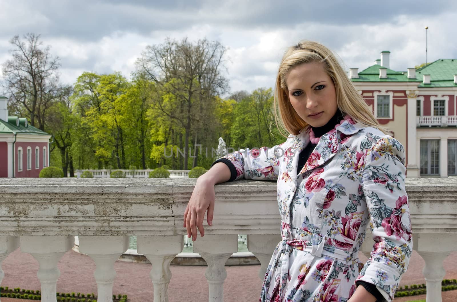 blonde girl standing against the background of an old palace by dmitrimaruta
