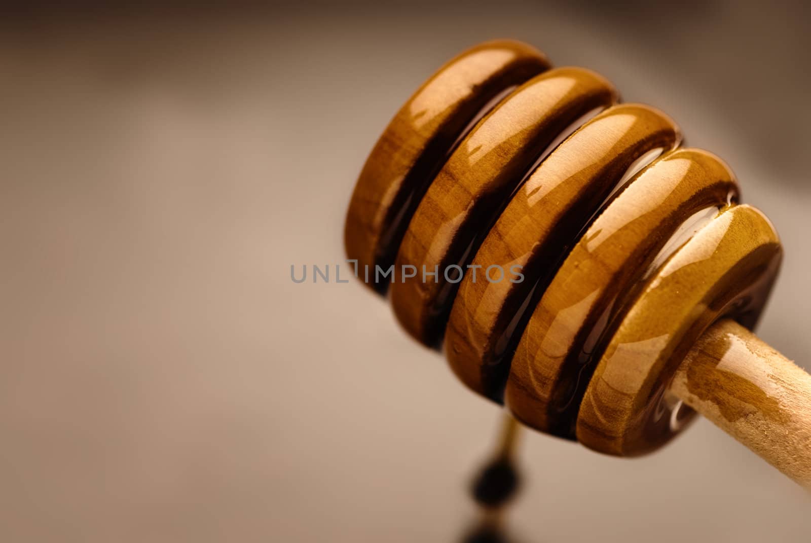 Bee nectar on a wooden honey dripper