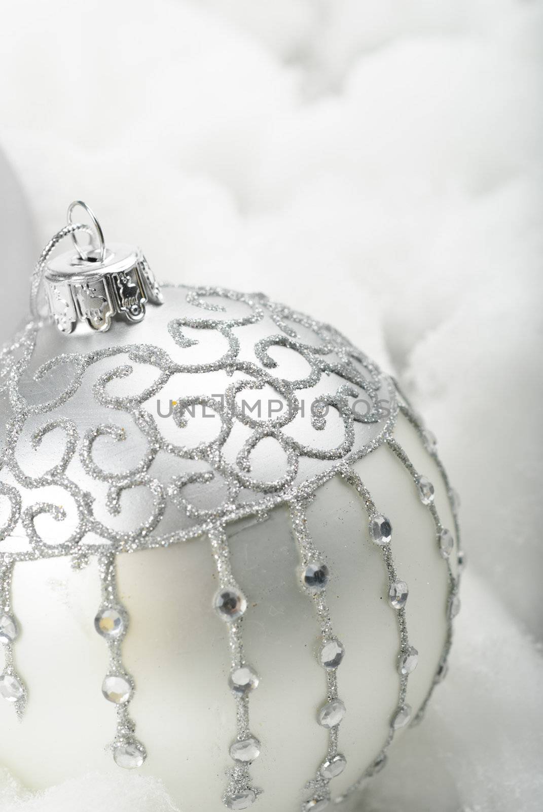 Silver christmas ornament in a white cotton snow