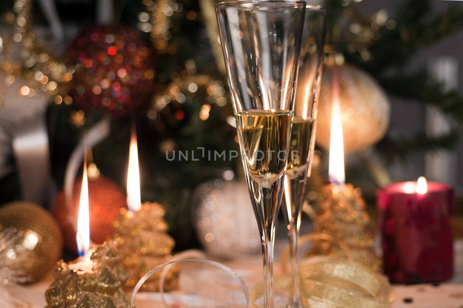 Christmas candles and Champagne glasses ready for celebration