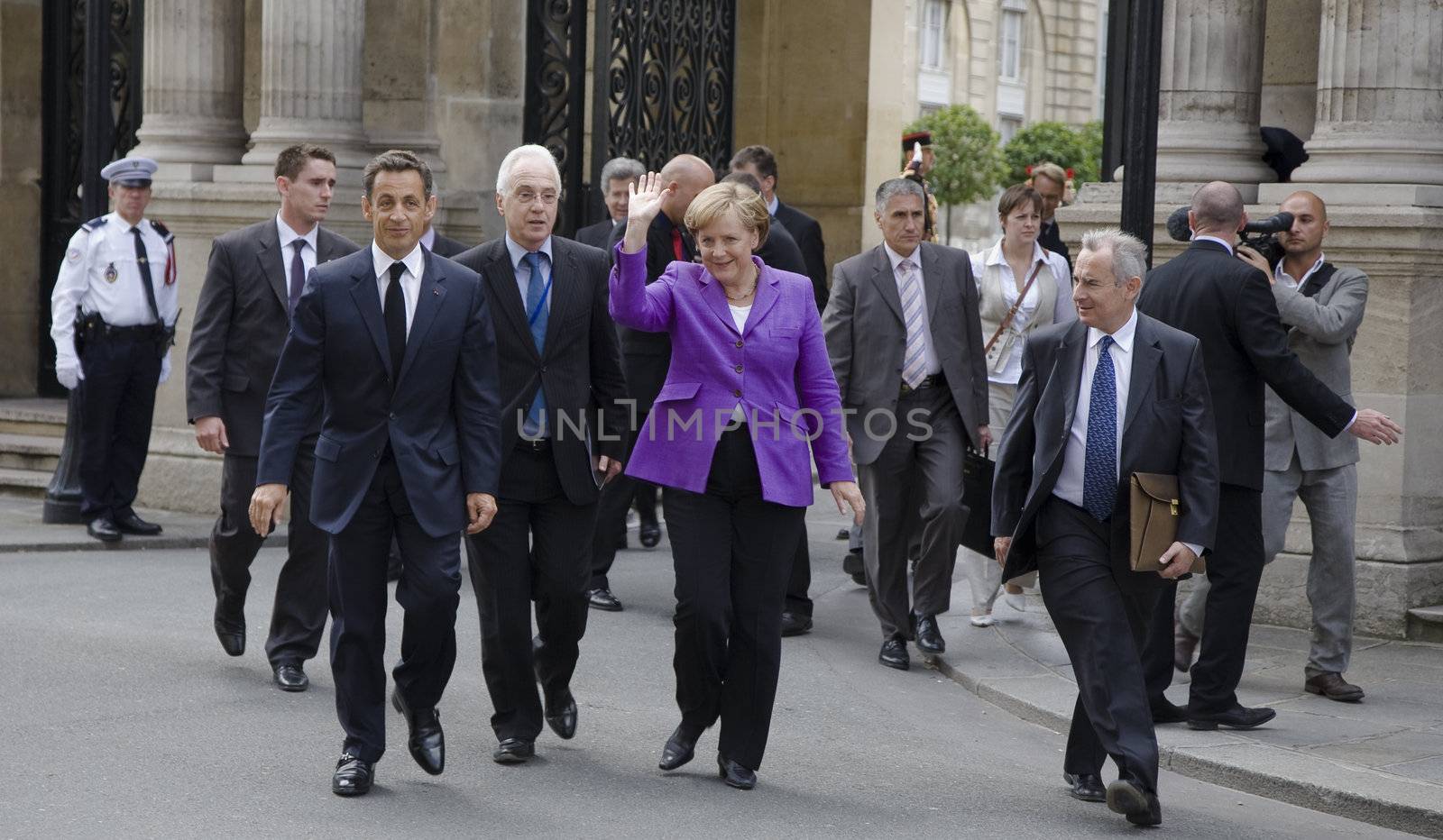 PARIS, FRANCE - JUNE 11 - 2009: French president Nicolas Sarkozy and German chancellor Angela Merkel outside the Elysee Palace on their way to lunch.