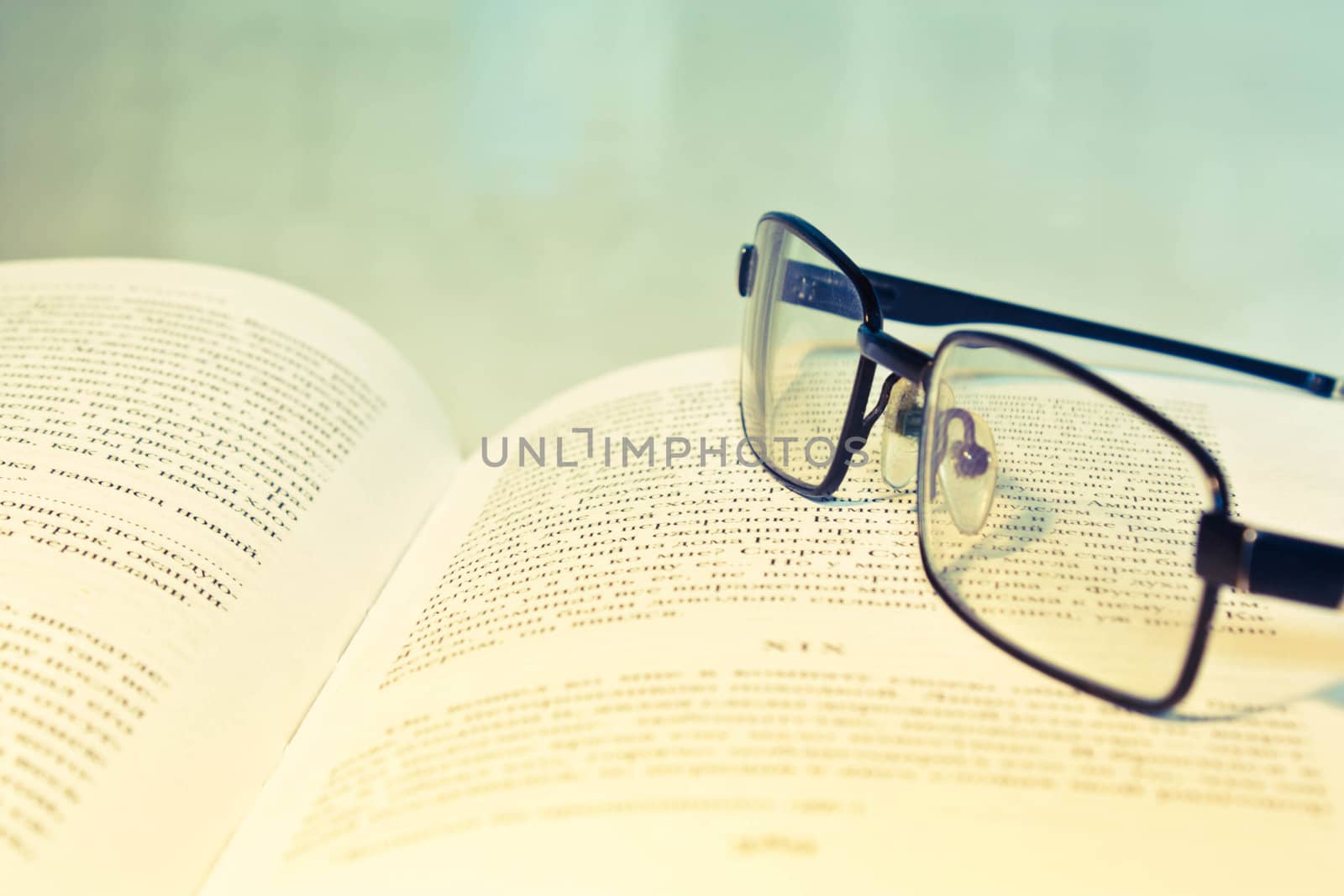 Closeup of opened book and glasses