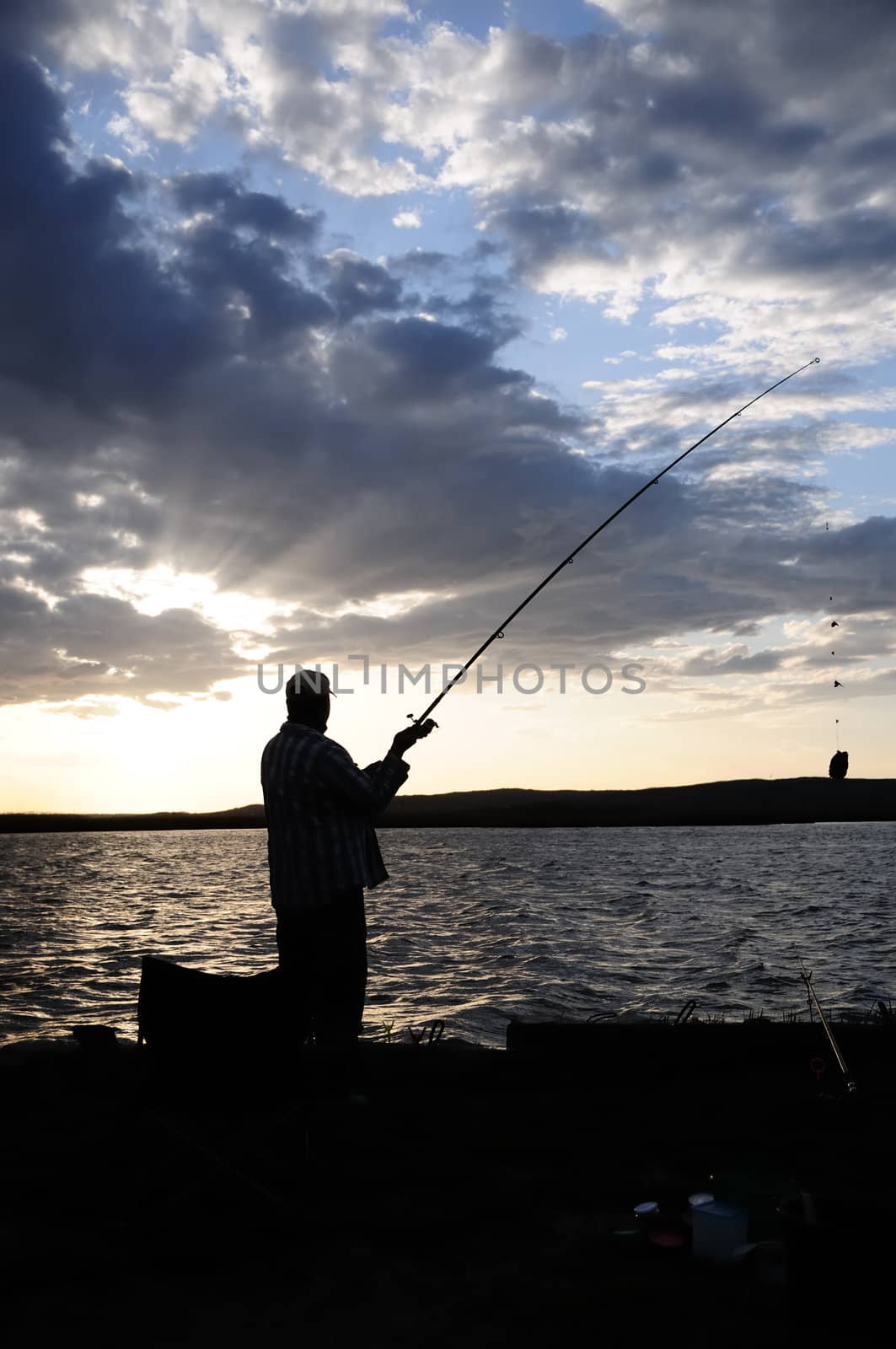 fisherman silhouette in sunset