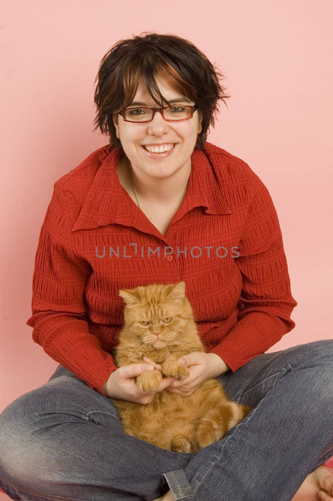 young beautiful woman holding a domestic red cat