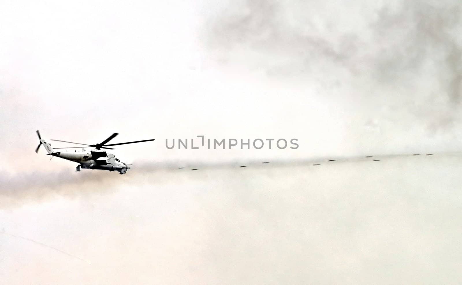 flying military  helicopter shoots