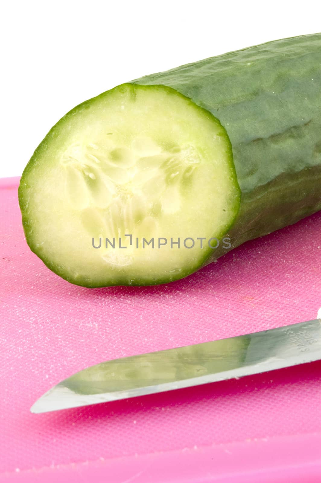 Part of a cucumber on a cutting board