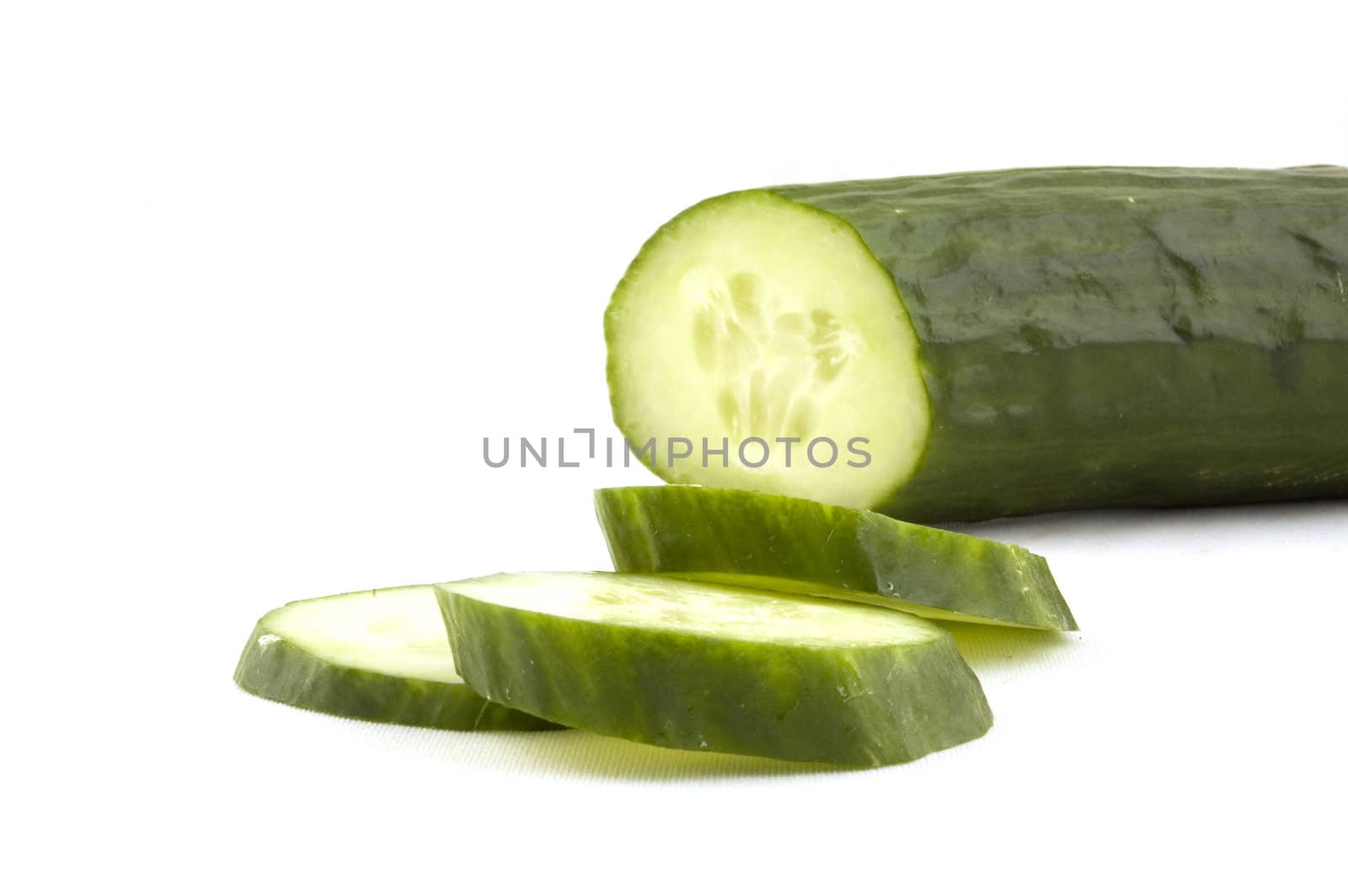 cucumber with slices isolated on white by ladyminnie