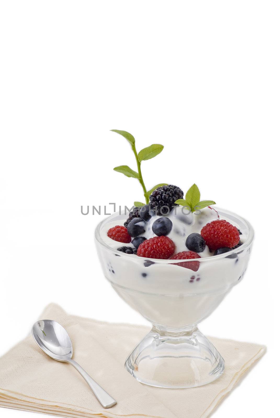 Fresh asorted summer berries in natural yogurt.
