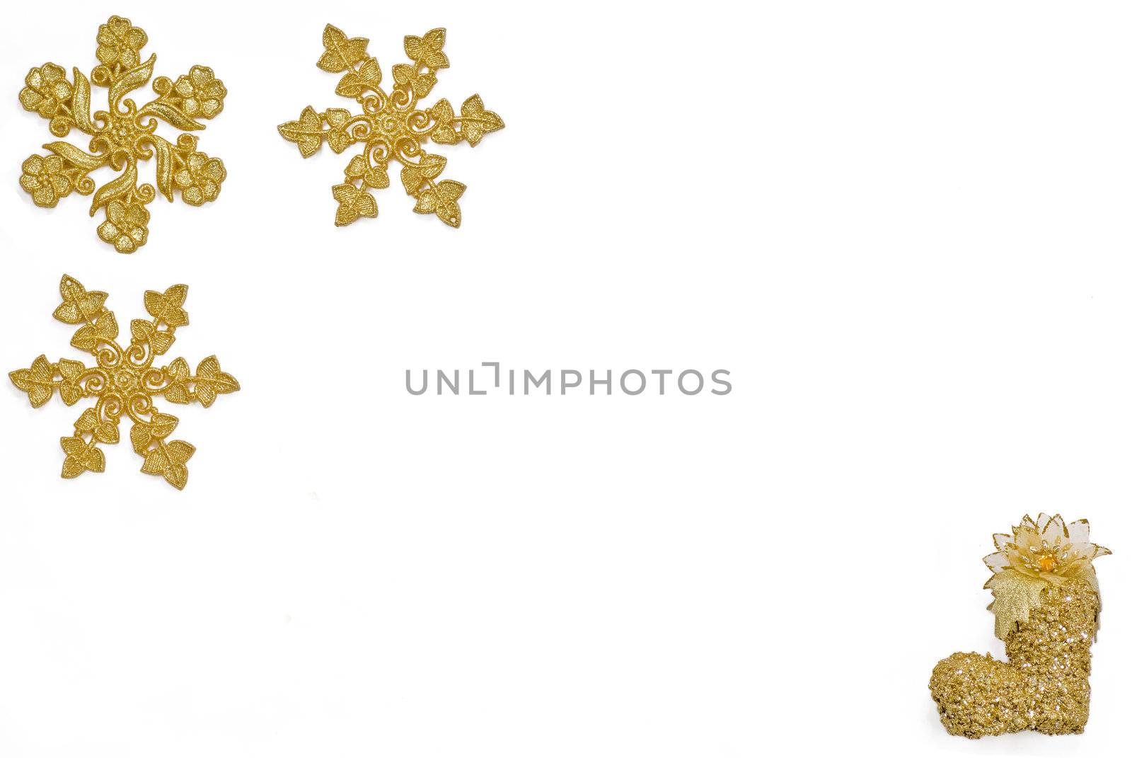 Golden snow stars and shoe on the pure white background
