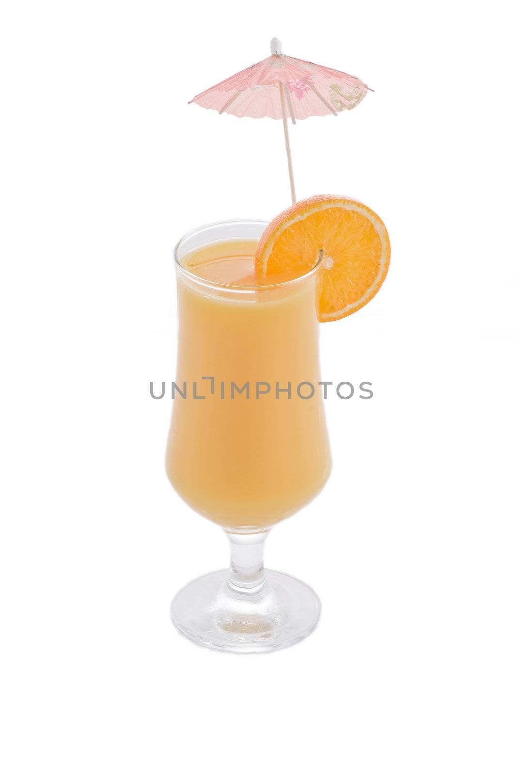 Glass of orange juice with slice of orange and drink umbrella