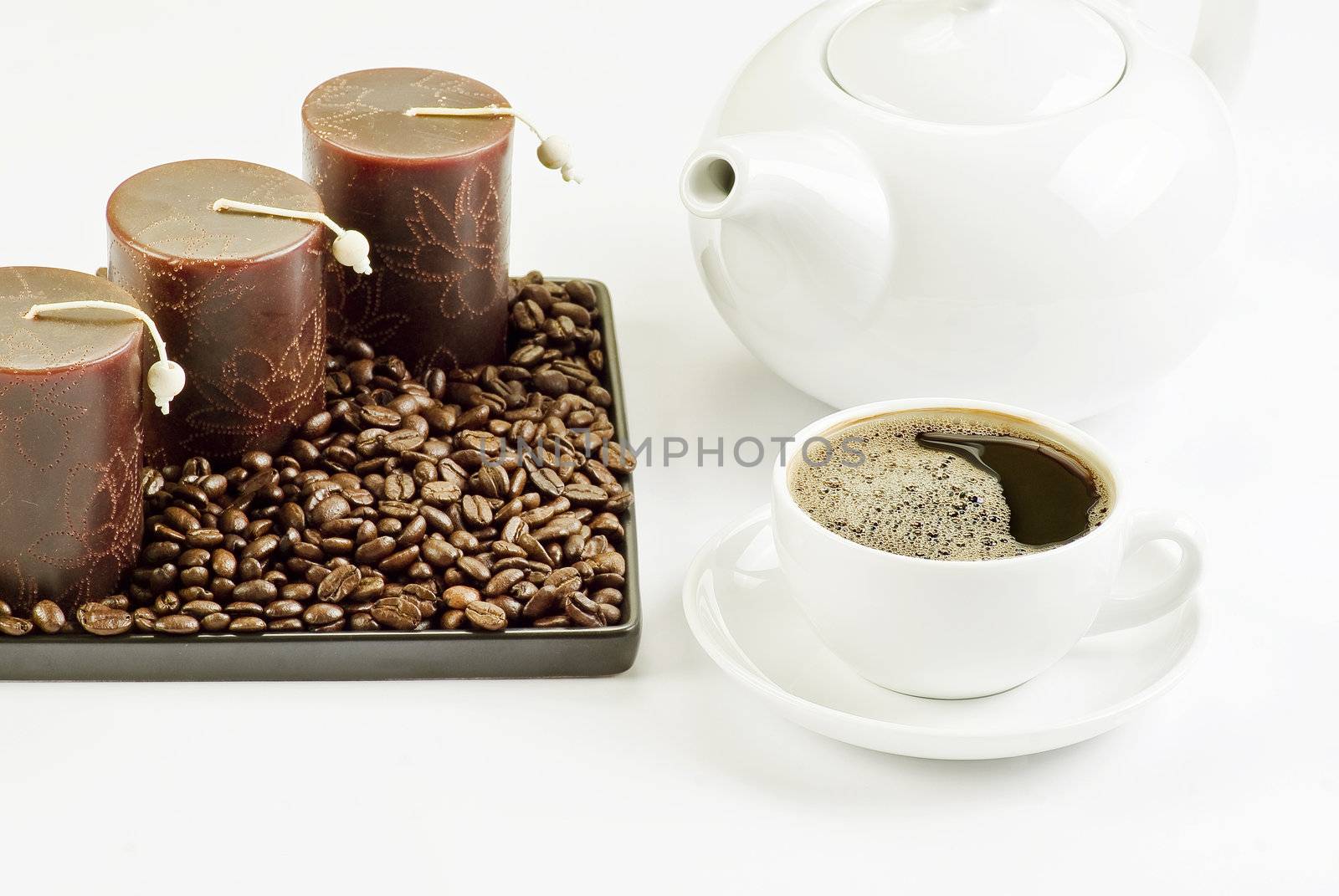 Cup of coffee with coffee beans and candles by caldix