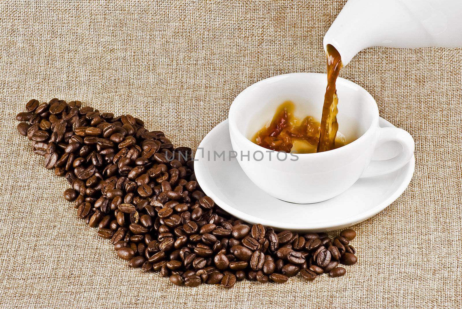 Pouring cup of coffee on burlap backround