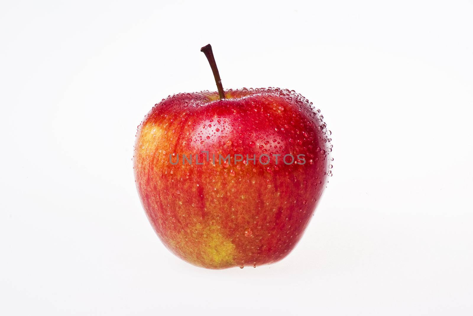 Red apple with water drops over white background - isolated