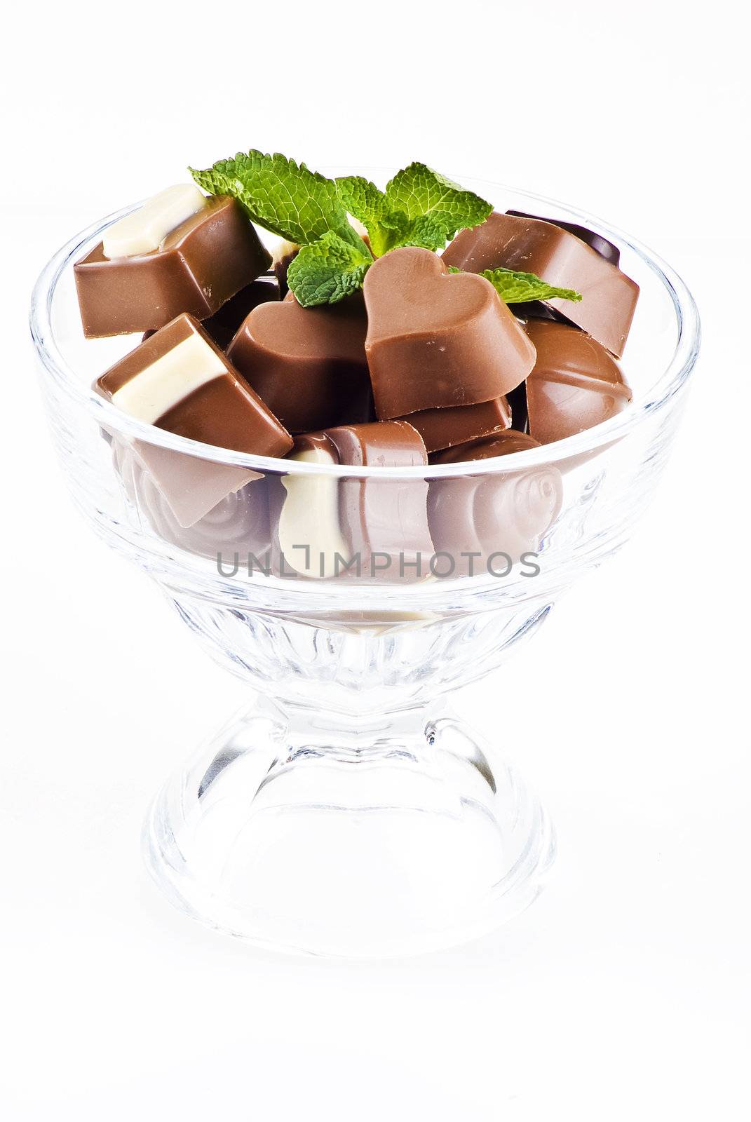 Glass bowl of chocolates and mint by caldix